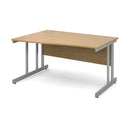 Dams Momento Wave Oak desk with cantilever leg, left side view showing sleek wood surface and modern design.