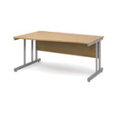 Dams Momento Wave Oak desk with cantilever leg, shown from the left side, featuring a sleek, modern design and natural oak finish.