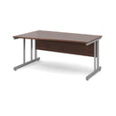 Walnut Dams Momento Wave Desk with cantilever leg, shown from the left side, featuring sleek modern design and smooth surface.