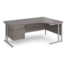 Dams Maestro 25 ergonomic desk with cantilever leg and fixed 3-drawer pedestal in grey oak finish, shown from left side.