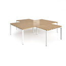 Dams Adapt Back to Back 4 Desk Cluster with Returns in oak wood, featuring a modern office workspace with multiple desks and work surfaces.