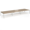 Dams Connex Plus Angled Triple Back To Back Desk in Kendal Oak wood finish, showing the workspace setup with desks and chairs.