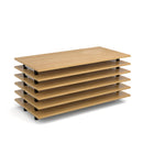 Stacked grey oak semi circular folding leg tables with curved foot rails by Dams, showing the smooth curved legs and foldable design.