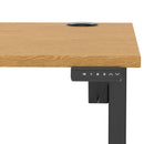 Dynamic Air Lite height adjustable desk with oak finish and built-in cable ports, perfect for ergonomic workspace setup.