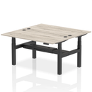 Grey oak adjustable back-to-back height bench desk for two people, featuring a modern design from Dynamic.