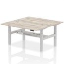 Gray oak adjustable back-to-back height bench desk for two people by Dynamic, featuring a modern design and sturdy construction.