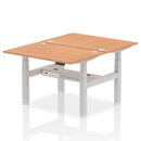 Dynamic Air 2-person back-to-back adjustable height oak desk bench showing wooden surface and adjustable legs.