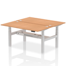 Dynamic Air 2-person back-to-back height adjustable oak bench desk showing sturdy wooden surface and adjustable metal legs.