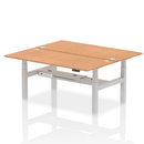 Dynamic Air 2 Person Back-to-Back Height Adjustable Oak Desk Bench showing the sturdy wood finish and ergonomic design.