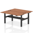 Dynamic Air 2-person back-to-back height adjustable walnut bench desk showing the wooden surface and adjustable metal legs.