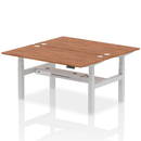 Dynamic Air 2-person back-to-back height adjustable walnut desk bench showing its sturdy wooden surface and adjustable legs.