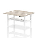 Dynamic Air 2-person back-to-back slimline height adjustable bench desk in grey oak wood finish, ideal for modern office spaces.