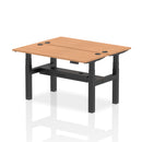 Two-person back-to-back slimline height adjustable desk bench with oak finish by Dynamic, showing the ergonomic design and sturdy frame.