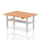 Dynamic Air 2-person back-to-back slimline height adjustable oak desk bench showing its sleek wooden surface and adjustable legs.