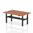 Dynamic Air 2-person back-to-back slimline height adjustable desk bench in walnut wood with metal frame and ergonomic design.