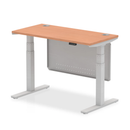 Dynamic Air 600mm deep height adjustable desk in beech with cable ports and steel modesty panel, shown in the image.