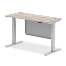 Grey oak Air 600mm deep height adjustable desk with cable ports and steel modesty panel by Dynamic.