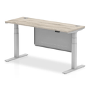 Grey oak Air 600mm deep height adjustable desk by Dynamic with cable ports and steel modesty panel, featuring a modern workspace design.