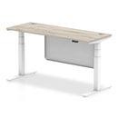 Grey oak Air 600mm deep height adjustable desk by Dynamic with cable ports and steel modesty panel, shown in the image.