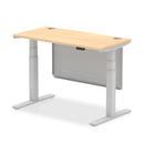 Dynamic Air 600mm deep height adjustable desk with cable ports and steel modesty panel in maple finish.