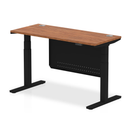Dynamic Air 600mm deep height adjustable desk in walnut with cable ports and steel modesty panel, shown from side view