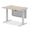 Grey Oak Air 800mm deep height-adjustable desk by Dynamic with cable ports and steel modesty panel.