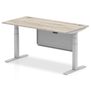 Dynamic Air 800mm deep height-adjustable desk in grey oak finish with cable ports and steel modesty panel, shown from side view.
