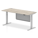 Gray oak Air 800mm deep height adjustable desk by Dynamic with cable ports and steel modesty panel in image.
