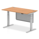 Dynamic Air 800mm deep height-adjustable oak desk with cable ports and steel modesty panel, showcasing the sturdy steel frame and wood finish.