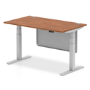 Dynamic Air 800mm deep height-adjustable desk with cable ports and steel modesty panel in walnut finish.