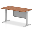 Dynamic Air 800mm deep height adjustable desk with cable ports and steel modesty panel in walnut finish.