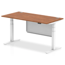 Dynamic Air 800mm deep height adjustable desk in walnut with cable ports and steel modesty panel, shown from a side view