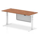 Dynamic Air 800mm deep adjustable desk in walnut with cable ports and steel modesty panel, shown from a side angle.