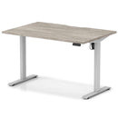 Dynamic Air Lite height adjustable desk with scalloped edge in grey oak finish, showcasing its sleek modern design and adjustable height feature.