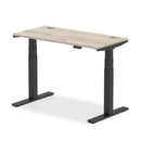 Grey oak air slimline height adjustable desk by Dynamic with cable ports, featuring a sleek modern design.