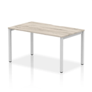 Gray oak Evolve Plus Single Starter Bench Desk by Dynamic, showing a modern, compact workspace with a sturdy design.