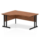 Dynamic walnut crescent desk with cantilever legs, showcasing a sleek, modern office workspace design.