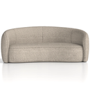 Dynamic Phoebe curved sofa with plush fabric, featuring a sleek, modern design and inviting seating in a stylish living room setting.