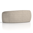 Curved Phoebe sofa by Dynamic with plush fabric upholstery and stylish design, shown in a cozy living room setting.