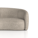 Curved Phoebe sofa by Dynamic featuring plush upholstery and stylish design, shown in a modern living room setting.