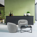 Dams Grace single swivel club chair with plush upholstery and dark wooden legs, shown in a modern living room setting.
