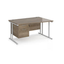 Dams Maestro 25 Wave desk with Nebraska Oak finish, cantilever legs, and fixed 2-drawer pedestal, shown from front angle.