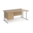 Dams Maestro 25 Wave Desk with cantilever legs and fixed 3-drawer pedestal in Kendal Oak finish, showing the desk's curved tabletop and drawers.
