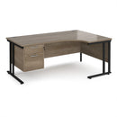 Dams Maestro 25 ergonomic desk with Nebraska Oak finish, cantilever legs, and fixed 2-drawer pedestal, shown in office setting.