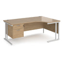 Dams Maestro 25 ergonomic desk with cantilever leg in Kendal Oak finish and fixed two-drawer pedestal.