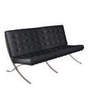 Black Valencia oversized leather-faced reception sofa with classic button design by Nautilus Designs, showcasing a contemporary style.