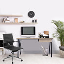 Nautilus Designs Tyrol Compact Workstation with oak top and black legs, featuring a suspended underdesk drawer, in a modern office setting.