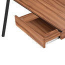 Nautilus Designs Tyrol compact workstation with walnut top and black legs, featuring suspended underdesk drawer and modern office setup.