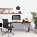 Nautilus Designs Tyrol compact workstation with walnut top and black legs, featuring a suspended underdesk drawer in a modern office setting.