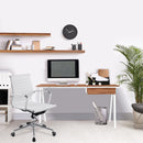 Nautilus Designs Tyrol compact workstation with walnut top and suspended underdesk drawer, shown in a modern office setting.